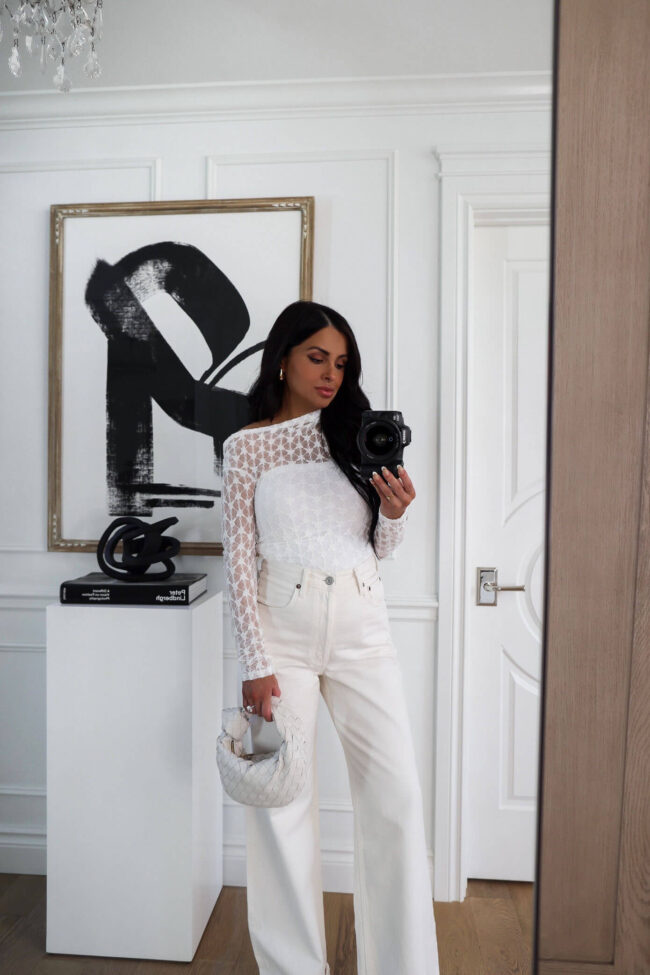 mia mia mine wearing a white lace top and white agolde denim with a bottega veneta mini jodie bag