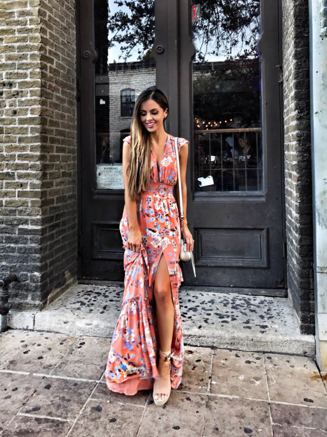 fashion blogger mia mia mine wearing a floral maxi dress from revolve