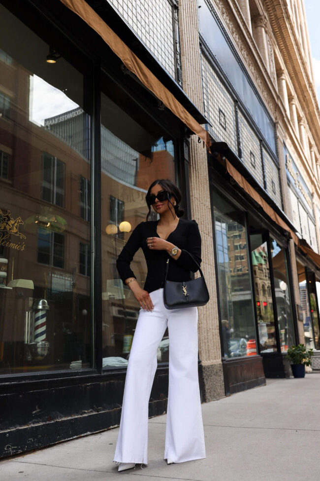 fashion blogger mia mia mine wearing a black cardigan and white jean from nordstrom