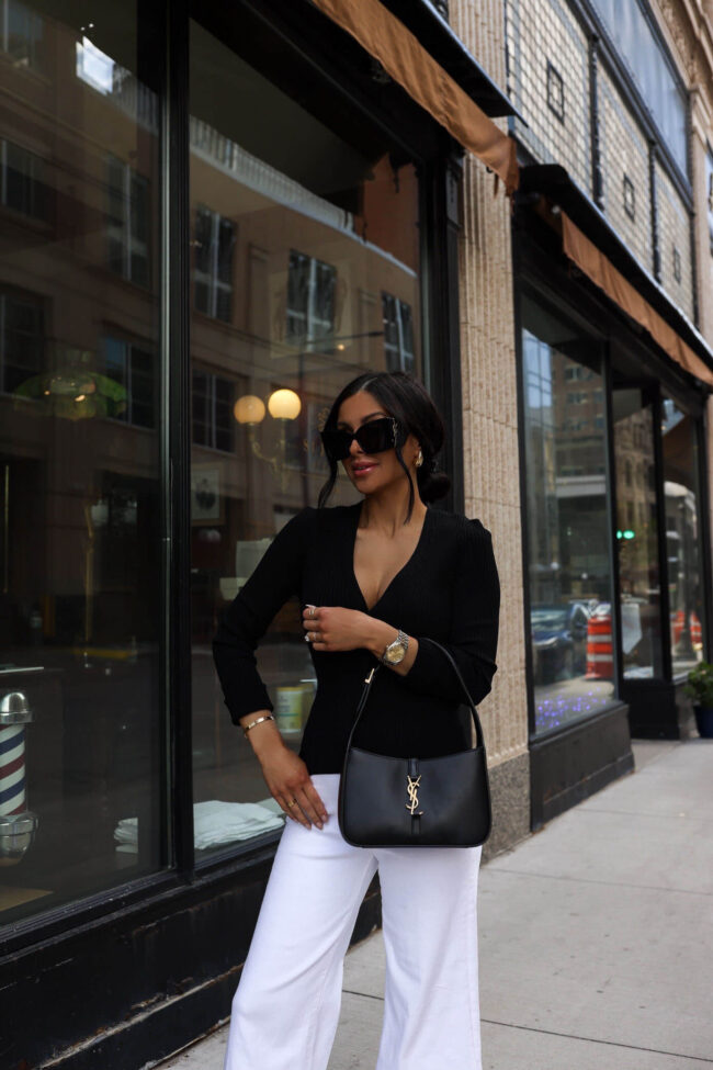 fashion blogger mia mia mine wearing a black cardigan and mother white denim from nordstrom