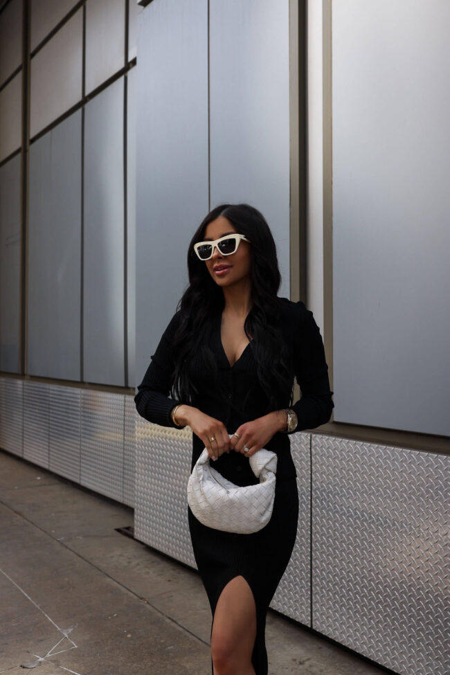 fashion blogger mia mia mine wearing a black cardigan and skirt by good american