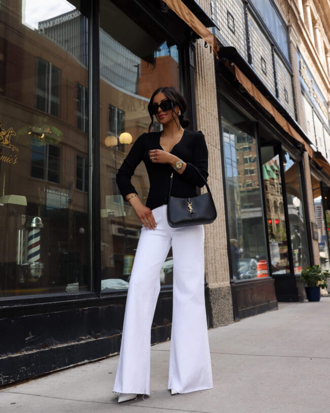 fashion blogger mia mia mine wearing a black cardigan and white jean from nordstrom