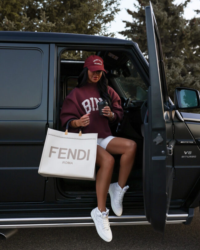 mia mia mine wearing an anine bing sweatshirt and baseball cap