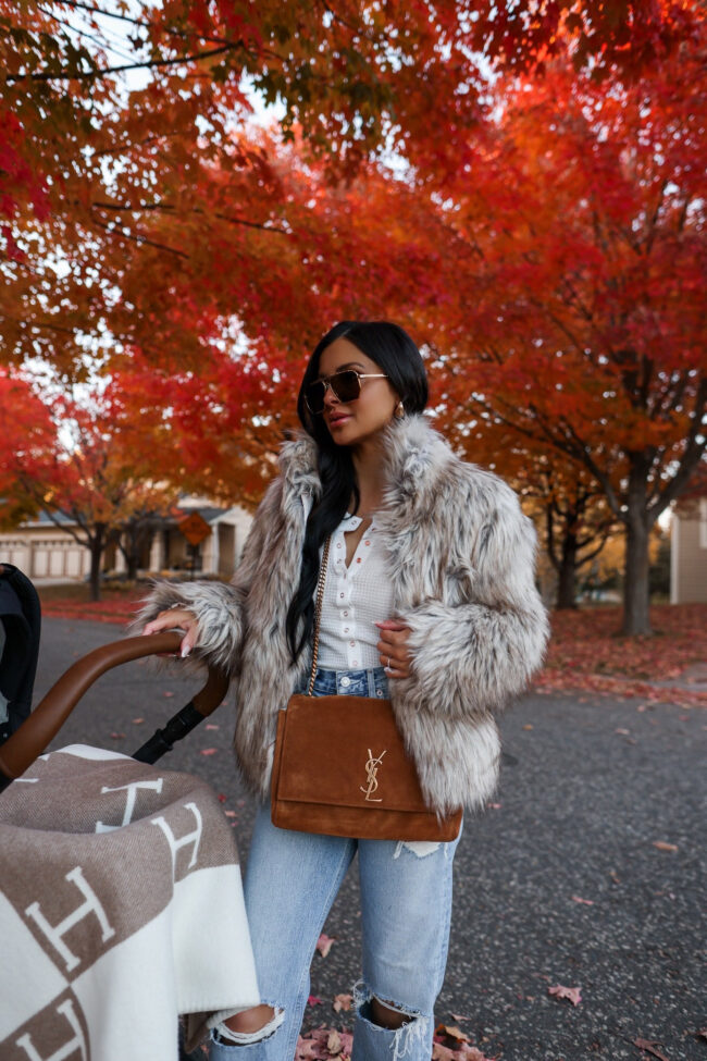 brunette fashion blogger wearing a faux fur coat from revolve